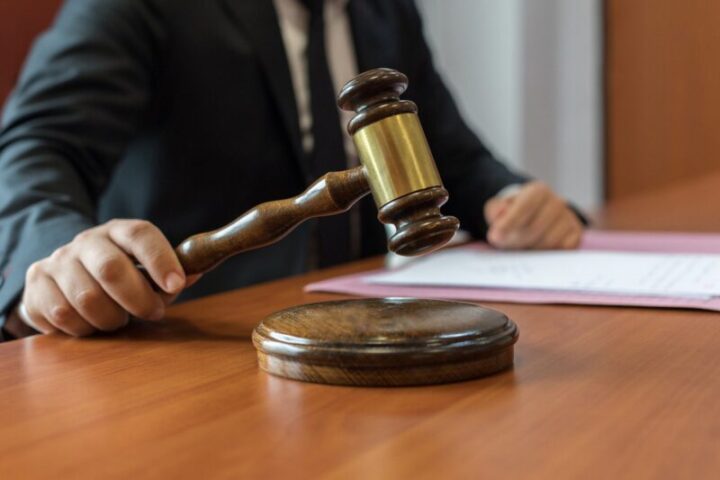 Professional attorney with wooden gavel and legal documents representing legal expertise and judicial authority